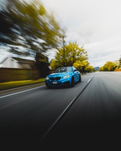 2016 Blue BMW 2 series front driving Kelowna fall
