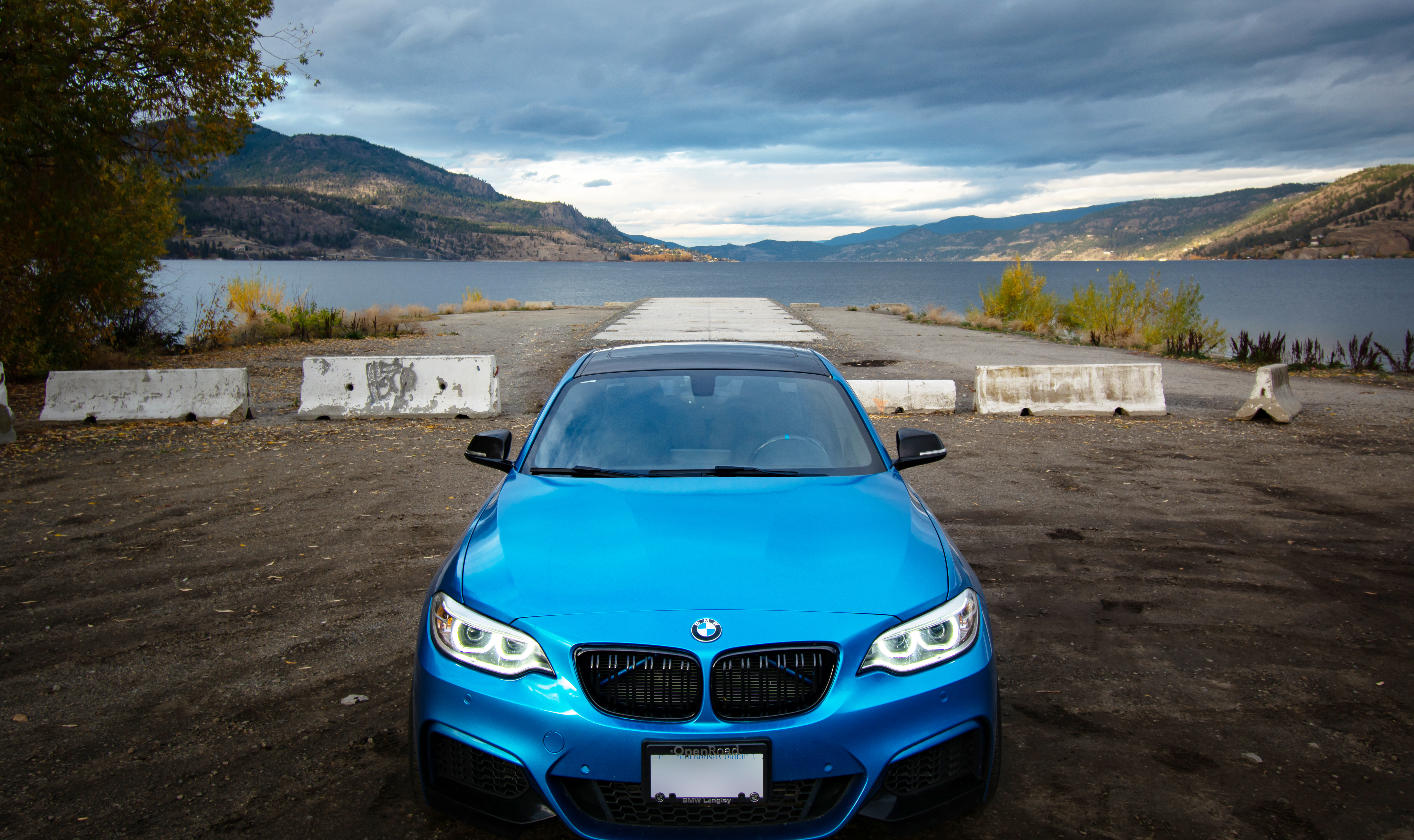 2016 Blue BMW 2 series upclose front with the backdrop of the lake