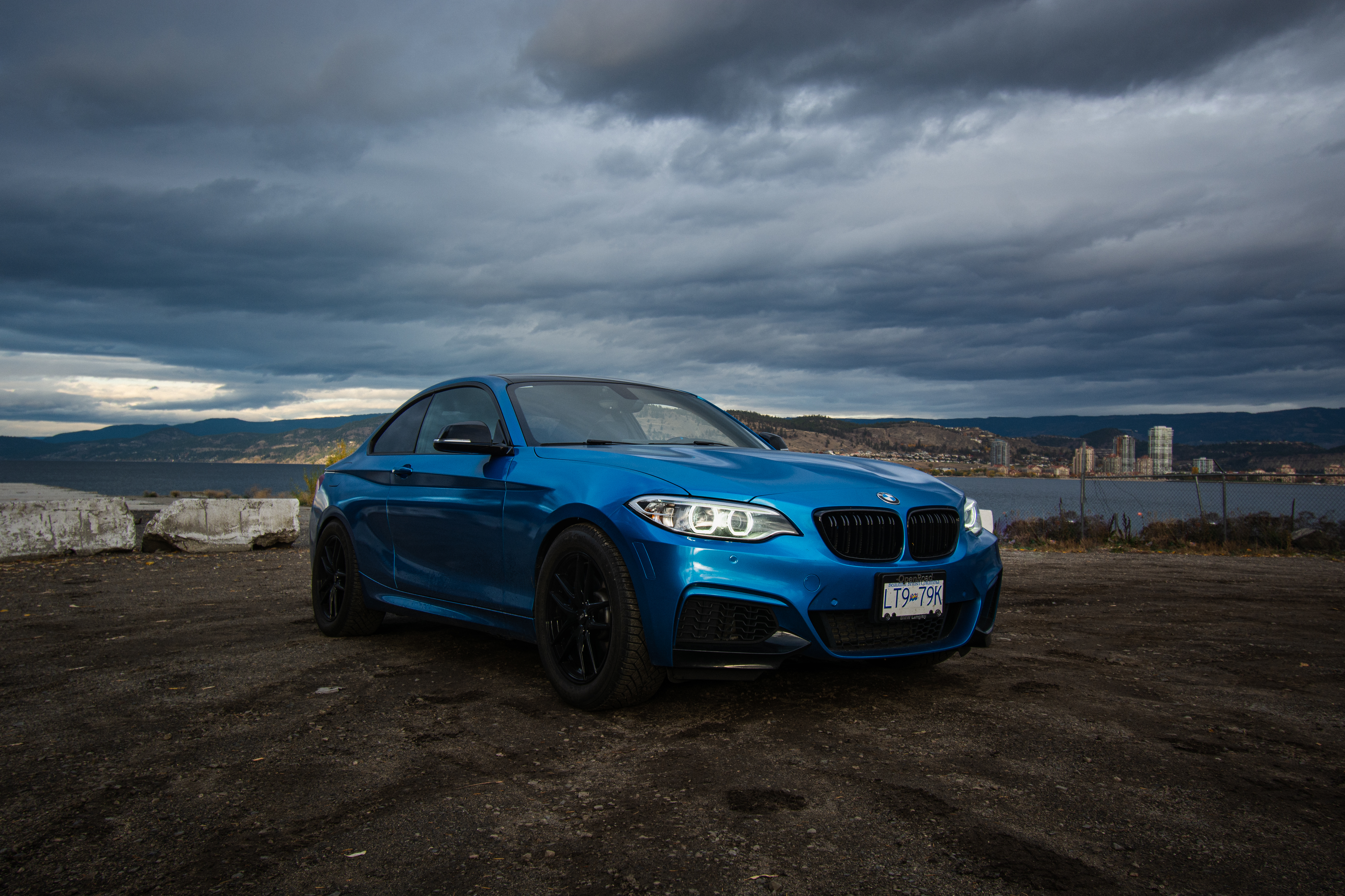 2016 Blue BMW 2 series front quarter side view with the backdrop of the lake